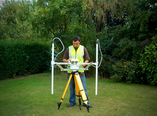 Archaeological geophysical survey equipment being used in the field to investigate potential buried archaeological features.